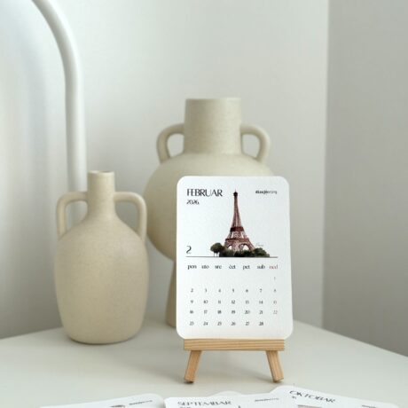 Elegant 2023 desk calendar with Eiffel Tower illustration, surrounded by cream ceramic vases, perfect for stylish interior decor.