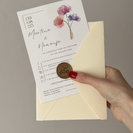 Wedding invitation card with watercolor flowers and gold foil details.