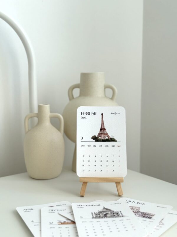 Elegant 2023 desk calendar with Eiffel Tower illustration, surrounded by cream ceramic vases, perfect for stylish interior decor.