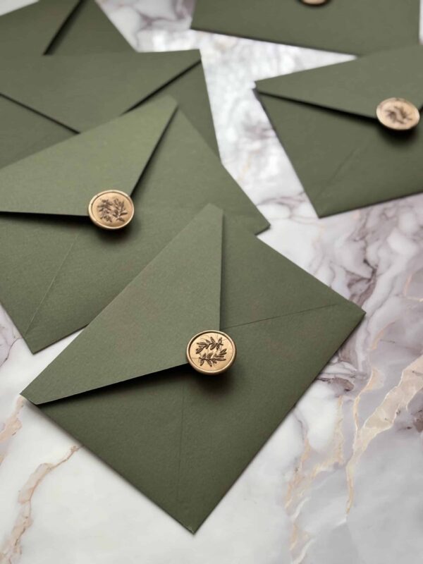 Elegant green envelopes with wax seals, perfect for special occasions and invitations.