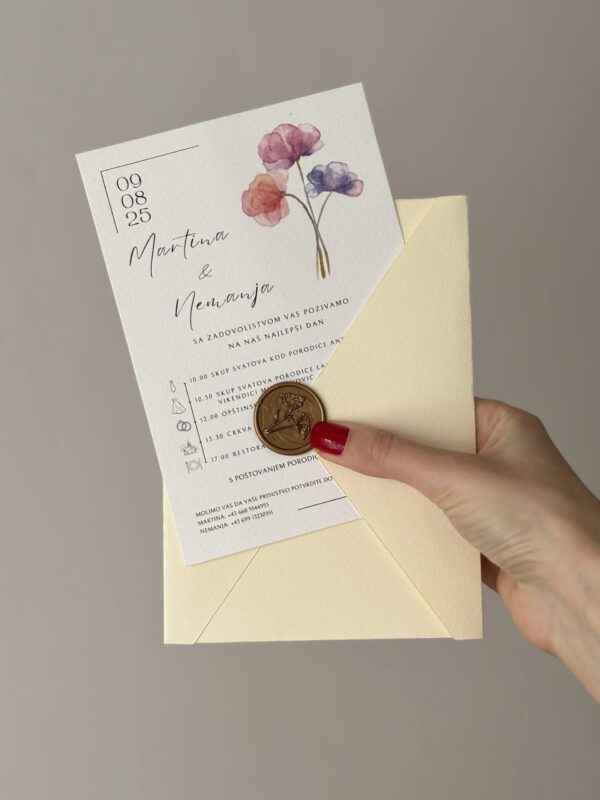 Wedding invitation card with watercolor flowers and gold foil details.
