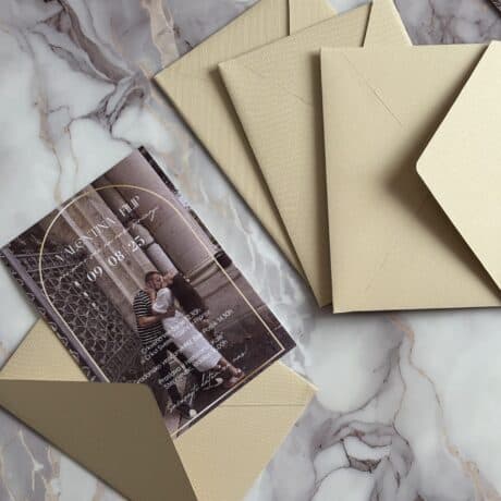 Wedding invitation card with envelopes on marble surface, elegant and personalized design.