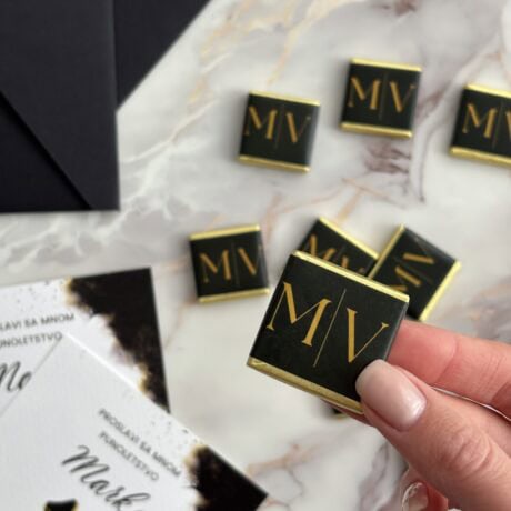 Elegant personalized chocolate favors with gold initials for special occasions.