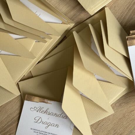 Wedding invitation card in elegant gold color, perfect for special occasions.