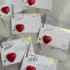 Love celebration wedding escort cards with red hearts and gold accents, perfect for romantic events.