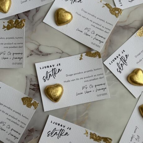 Heart-shaped golden chocolates on thank you cards.