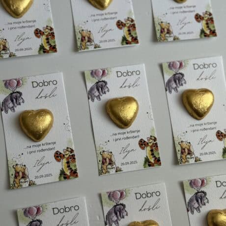 Heart-shaped gold chocolate on thank you card.