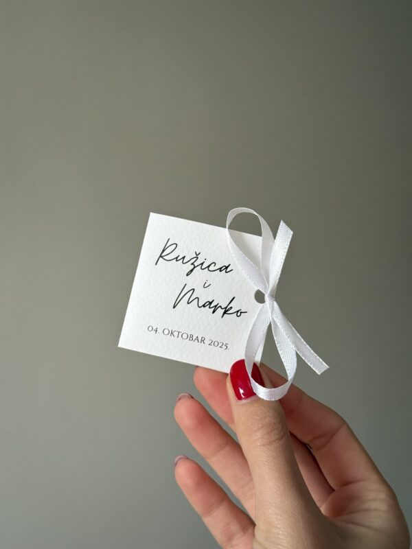 Thank you card with elegant white ribbon and handwritten names.