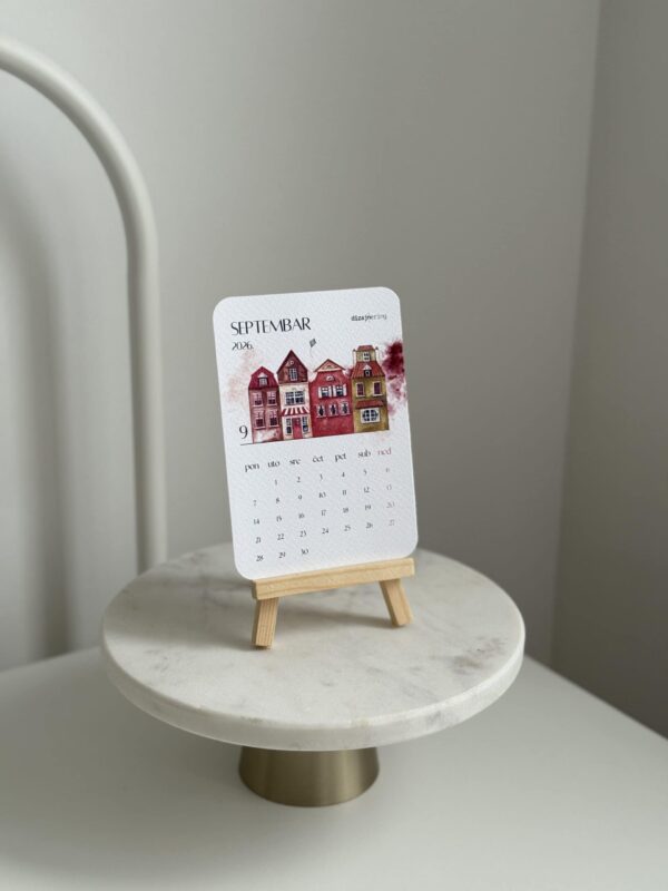 Colorful miniature house calendar for September 2026 on wooden stand, modern home decor.