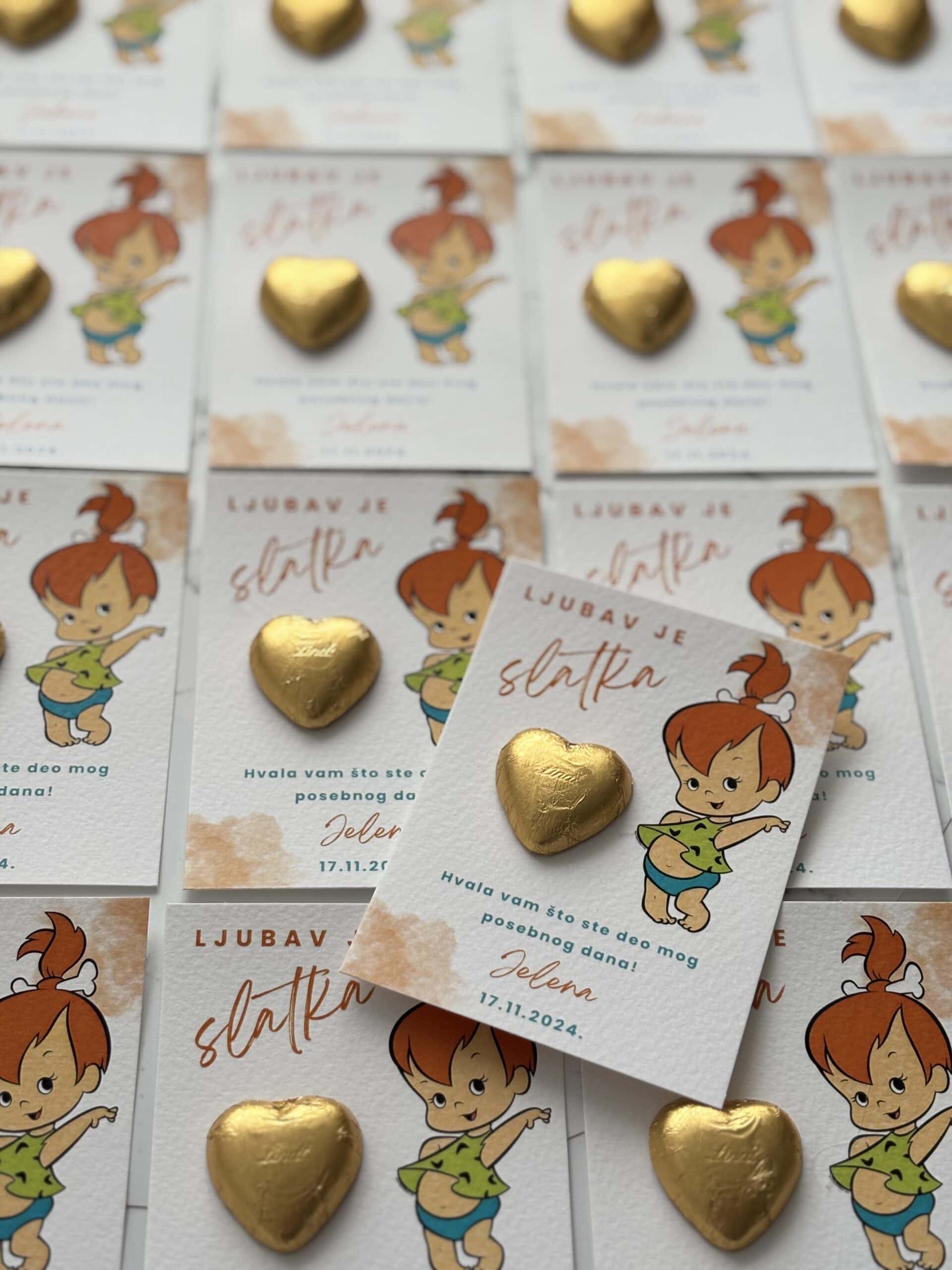 Heart-shaped chocolates on personalized thank you cards for "Ljubav je slatka" event.
