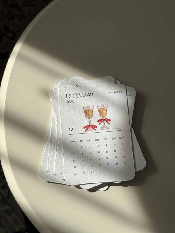 Elegant December 2026 desk calendar with watercolor champagne glasses illustration.