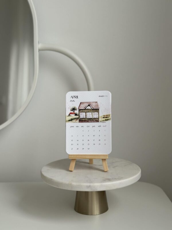 Minimalist desktop calendar with house illustration for interior design decor.