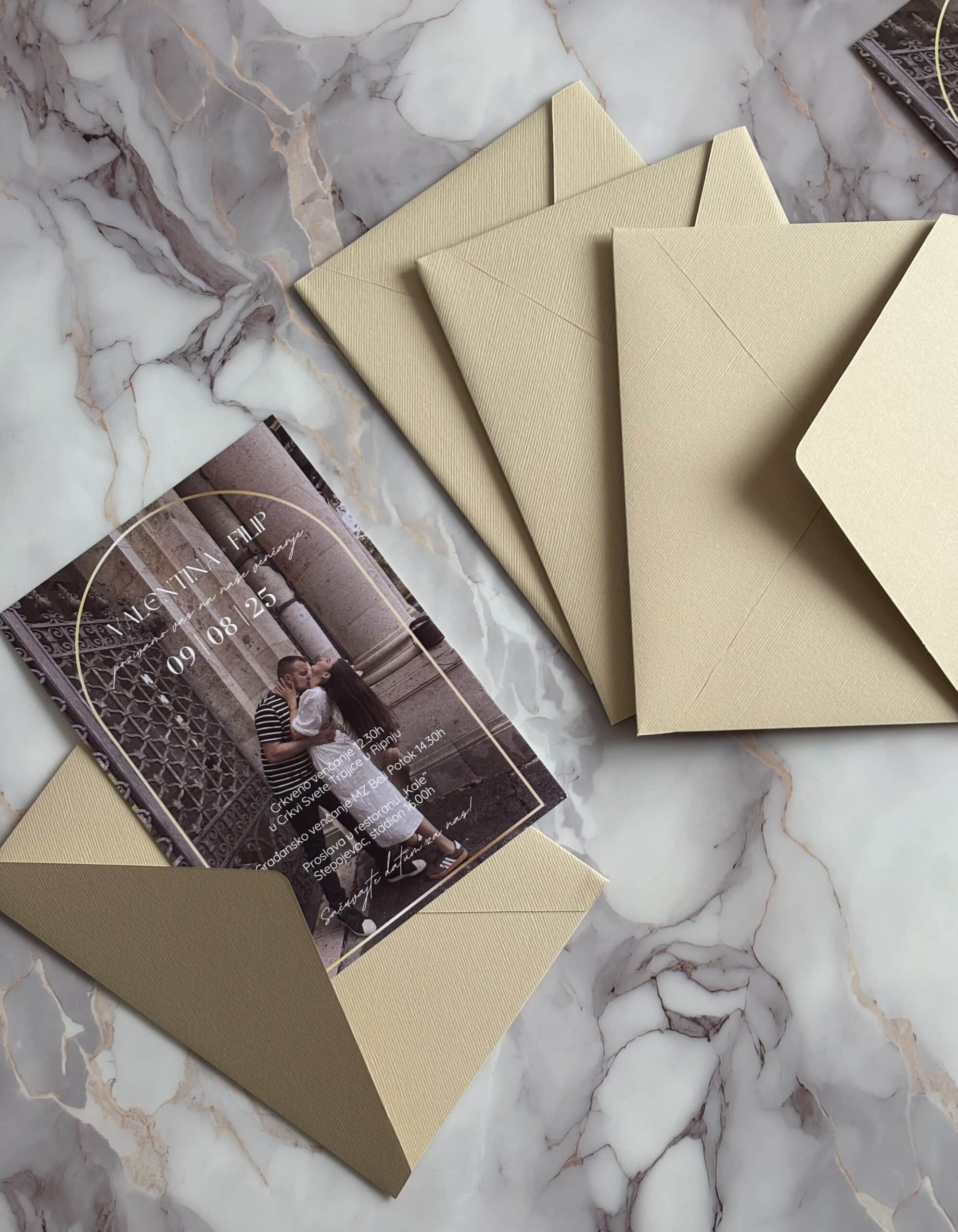 Wedding invitation card with envelopes on marble surface, elegant and personalized design.