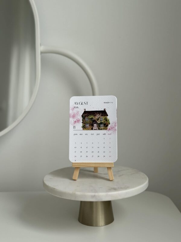 Elegant home decor calendar on mini easel, modern interior design, stylish office and living room accessories.