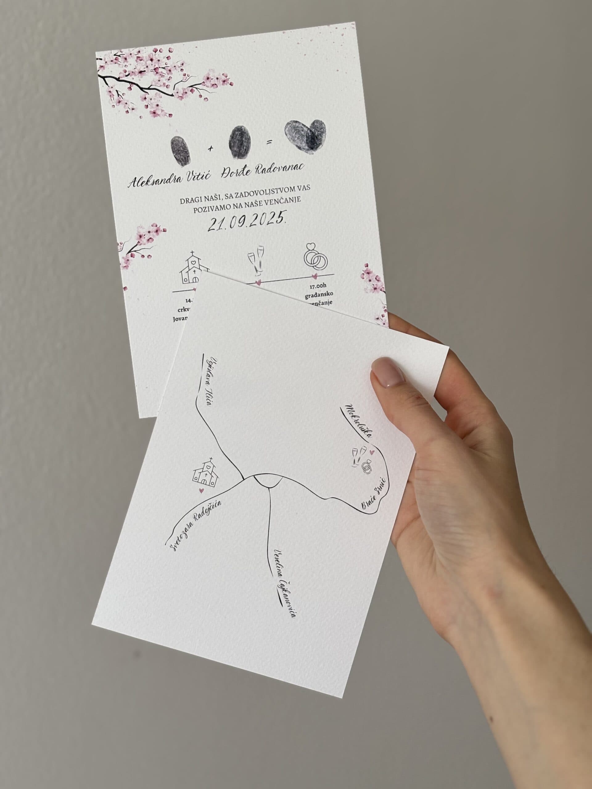 Wedding invitation with fingerprint heart design and personalized details.