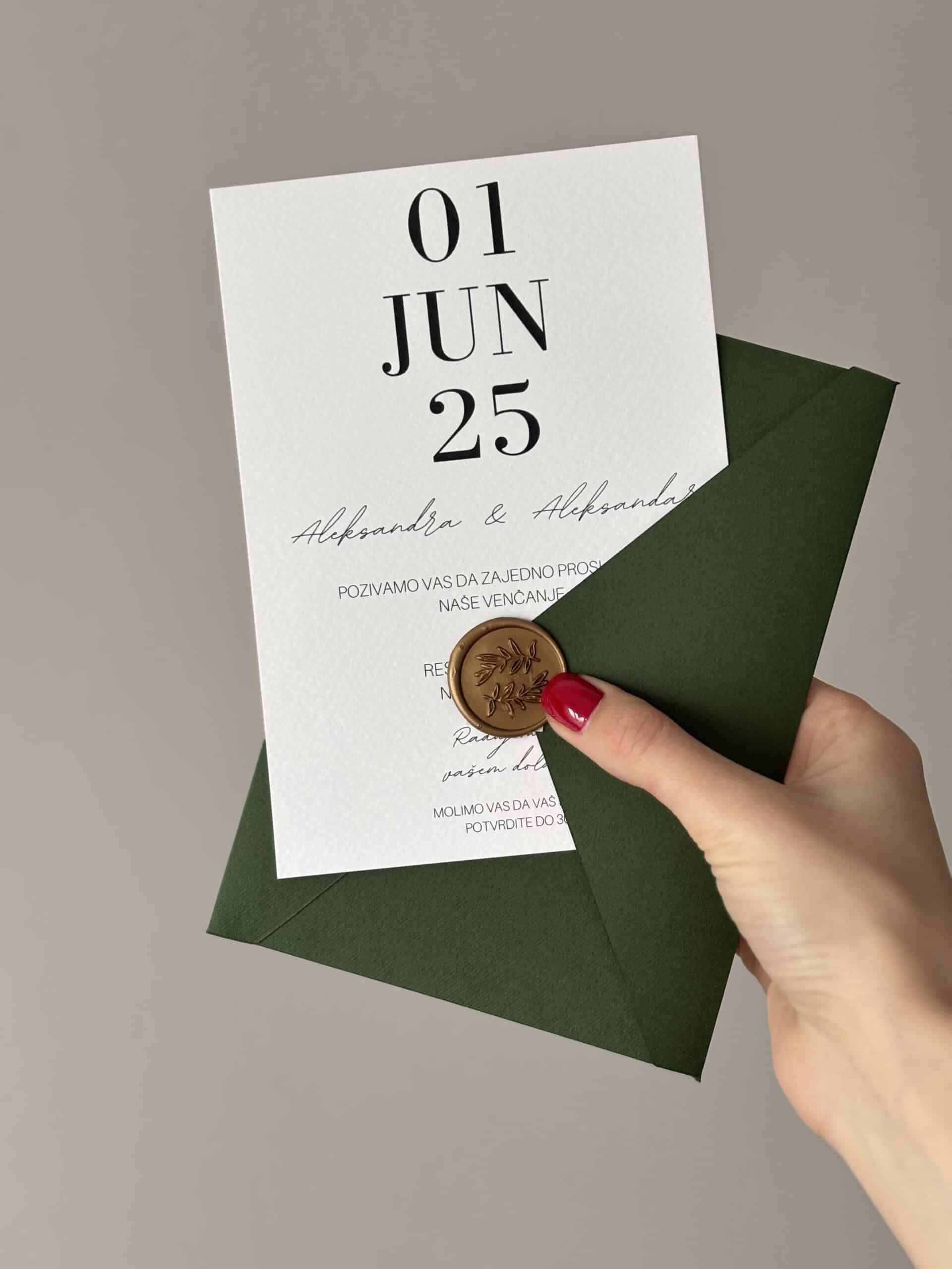 Elegant green wedding invitation with date and seal for a stylish wedding.