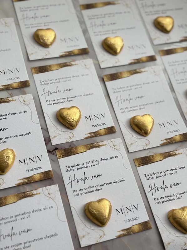 Golden heart-shaped chocolates on wedding invitations for Zahvalnica-Hvala vam 5 event.