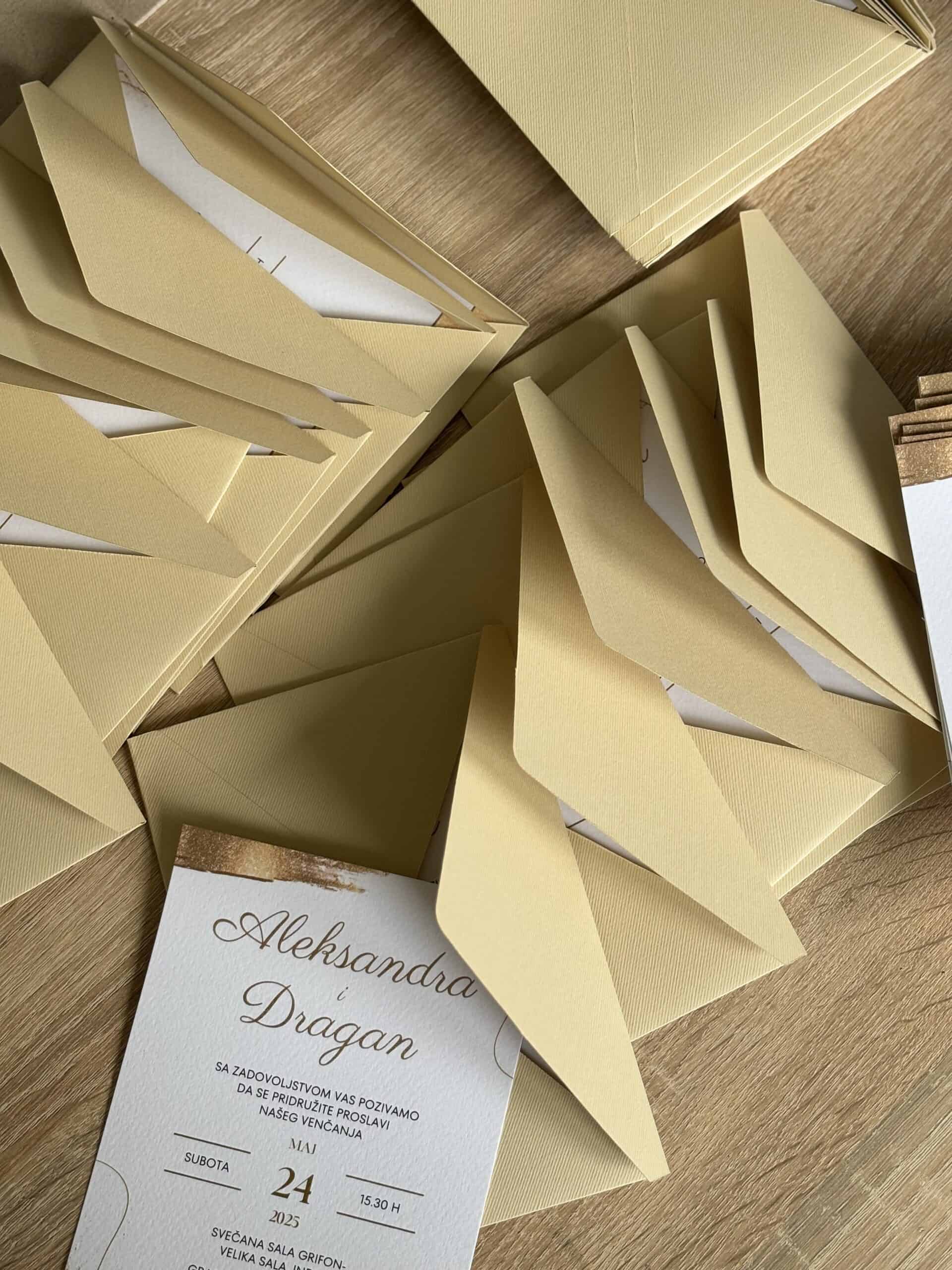 Wedding invitation card in elegant gold color, perfect for special occasions.