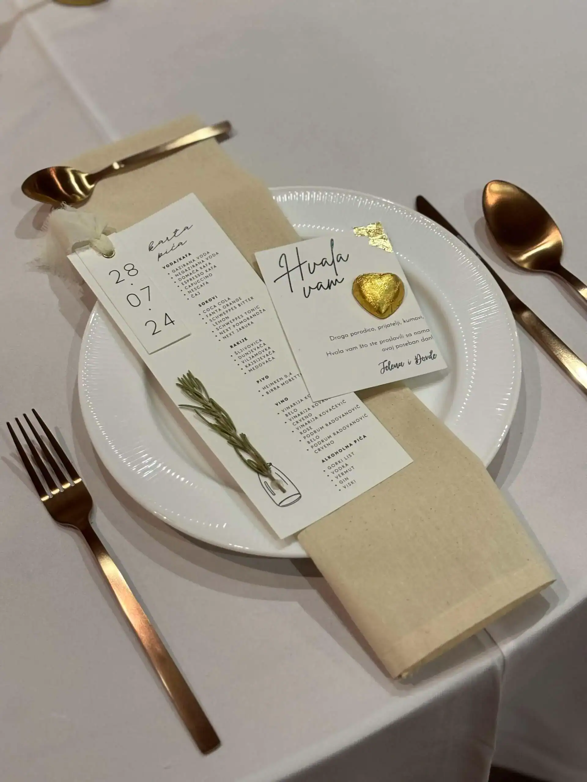 Elegant wedding table setting with personalized menu and gold accents for a stylish event.